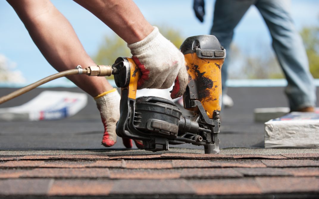 Closeup of a drill being used to repair a roof