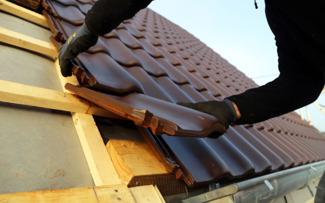 close up of a shingle being added to a roof