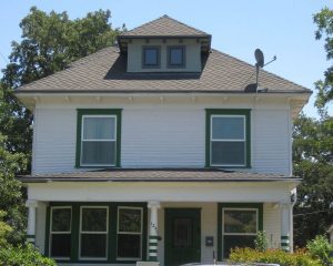 white square house with green trim