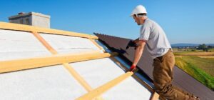 a man working on a roof with a ladder