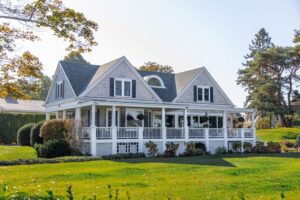 a large white house with a porch and a lawn