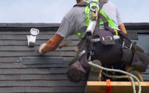 a man is working on a roof with a ladder