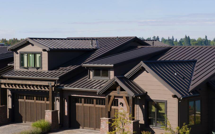 a house with a metal roof and two garages