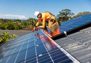 A worker installing solar panel in residential roofing while also caring for safety.