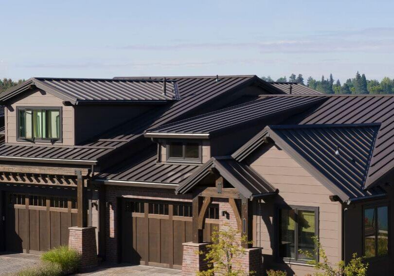 a house with a metal roof and two garages